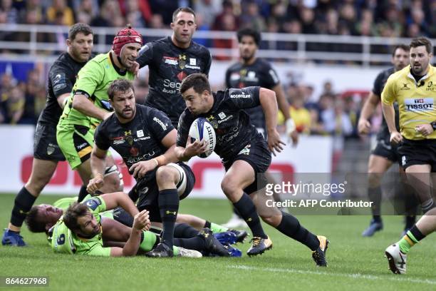 Clermont's French scrum-half Charlie Cassang runs on his way to score a try during the European Rugby Champions Cup match ASM Clermont Auvergne vs...