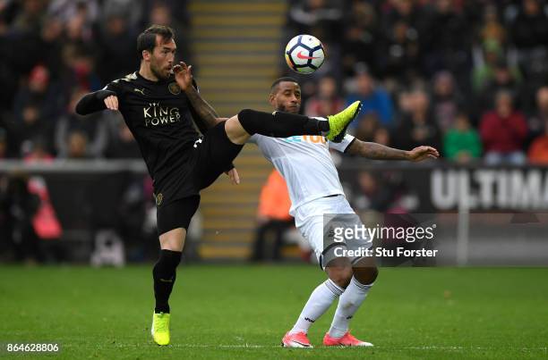 Christian Fuchs of Leicester City and Luciano Narsingh of Swansea City clash during the Premier League match between Swansea City and Leicester City...