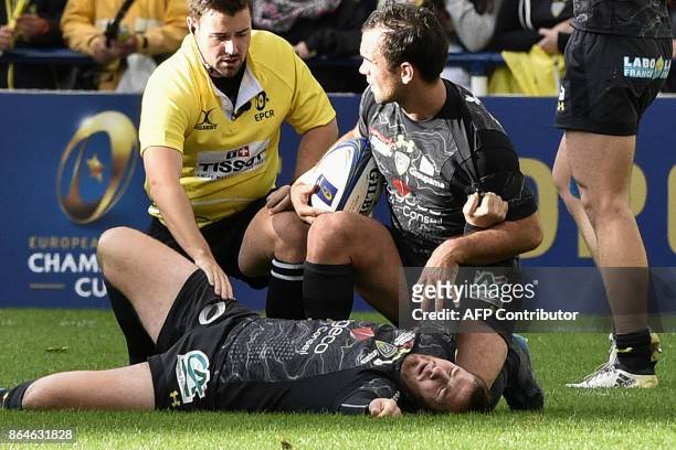 Clermont's French fly-half Camille Lopez lies in pain on the pitch after suffering an injury during the European Rugby Champions Cup match ASM...
