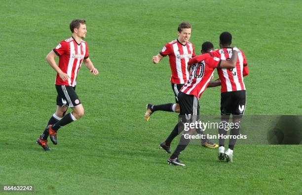 Florian Jozefzoon of Brentford is swamped by team-mates after he scores their second goal with a free kick during the Sky Bet Championship match...