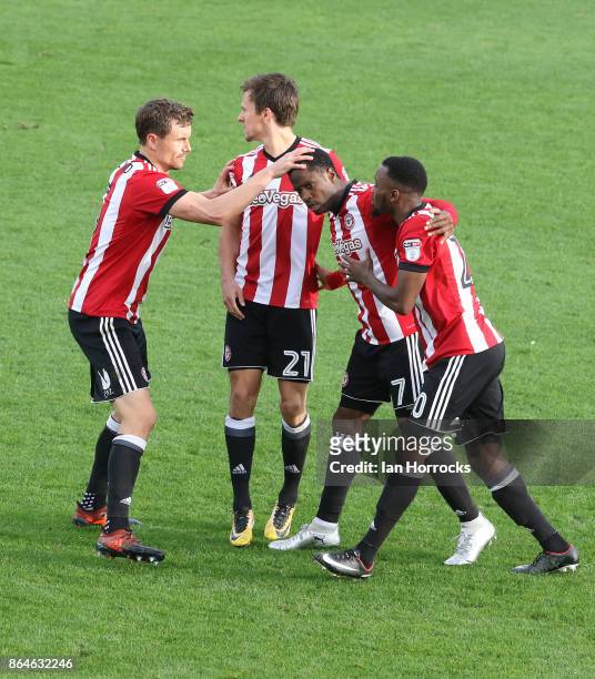 Florian Jozefzoon of Brentford is swamped by team-mates after he scores their second goal with a free kick during the Sky Bet Championship match...