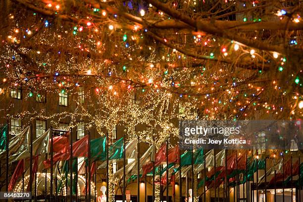 christmas tree and flags, rockefeller center, new york city - rockefeller centre christmas stock pictures, royalty-free photos & images
