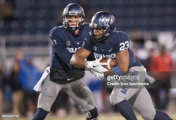 Nevada Wolf Pack quarterback Ty Gangi hands the ball off to Nevada Wolf Pack running back Kelton Moore during the game between the Nevada Wolf Pack...