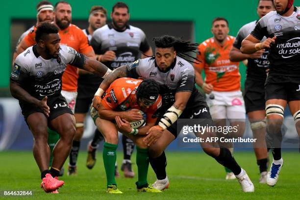 Benetton Treviso's Irish fullback Ian McKinley is tackled by RC Toulon's New Zealander centre Ma'a Nonu and RC Toulon's Fijian winger Josua Tuisova...