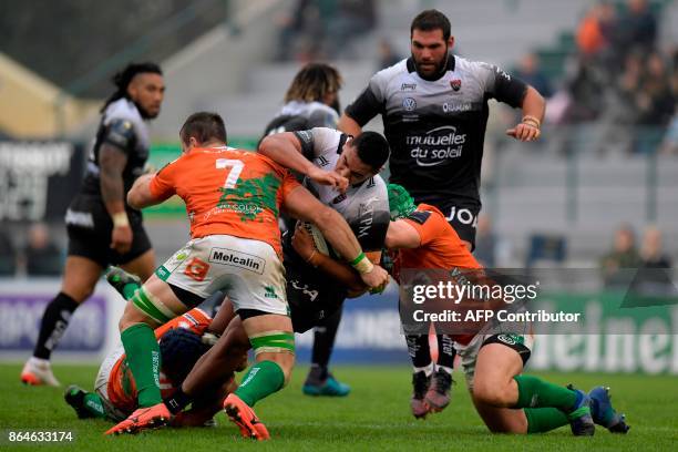 Toulon's French flanker Rudy Gahetau is tackled by Benetton Treviso's Italian flanker Abraham Steyn and Benetton Treviso's Italian hooker Luca Bigi...