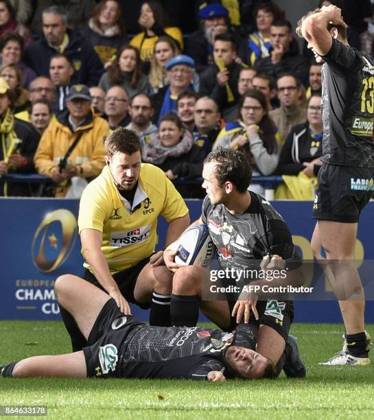 Clermont's French fly-half Camille Lopez lies in pain on the pitch after suffering an injury during the European Rugby Champions Cup match ASM...