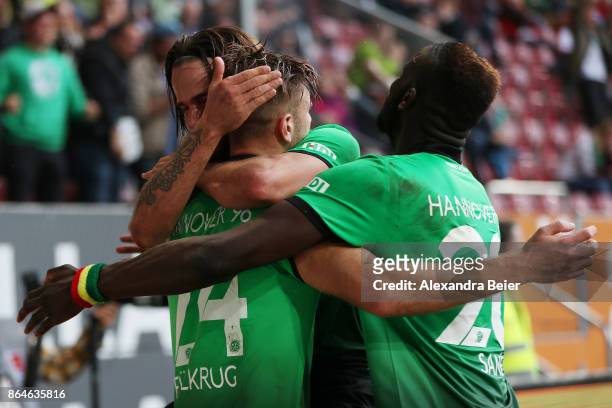 Niclas Fuellkrug of Hannover celebrates with Martin Harnik of Hannover and Salif Sane of Hannover after he scored the winning goal for Hannover to...