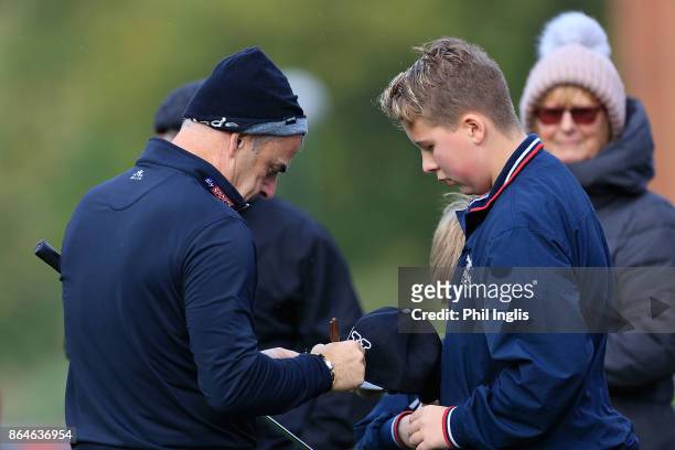 Paul McGinley of Ireland signs autographs on the 9th green during the second round of the Farmfoods European Senior Masters played at Forest of Arden...