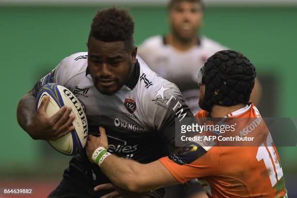 Toulon's Fijian winger Josua Tuisova is tackled by Benetton Treviso's Irish fullback Ian McKinley during the European Rugby Champions Cup match...
