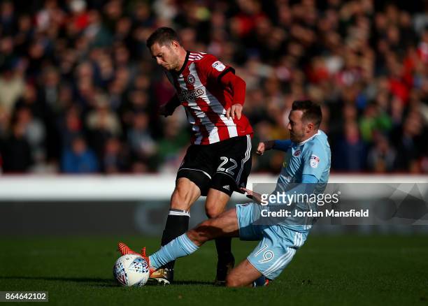 Henrik Dalsgaard of Brentford is tackled by Aiden McGeady of Sunderland during the Sky Bet Championship match between Brentford and Sunderland at...