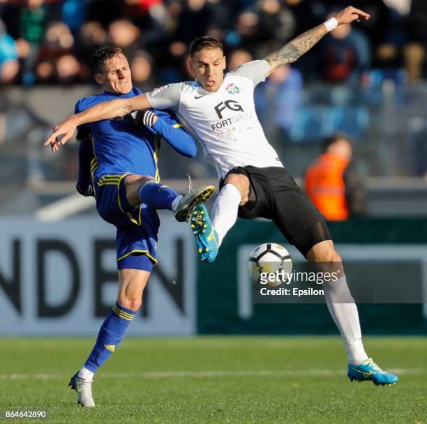 Rade Dugalic of FC Tosno and Vladimir Dyadyun of FC Rostov vie for the ball during the Russian Football League match between FC Tosno and FC Rostov...