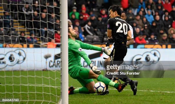 Shinji Okazaki of Leicester City scores the 2nd Leicester goal past Swansea goalkeeper Lucasz Fabianski during the Premier League match between...