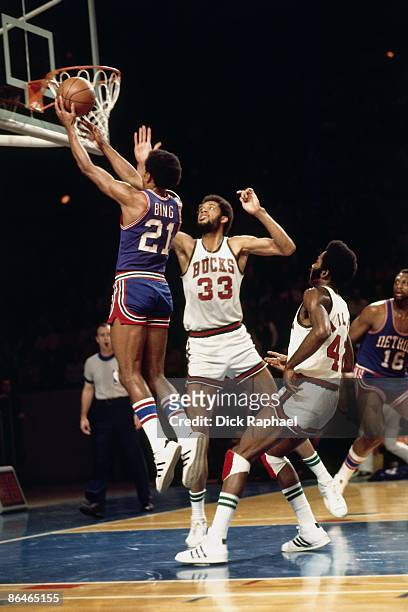 Dave Bing of the Detroit Pistons shoots a layup against Kareem Abdul-Jabbar of the Milwaukee Bucks during a game played in 1974 at the Mecca in...