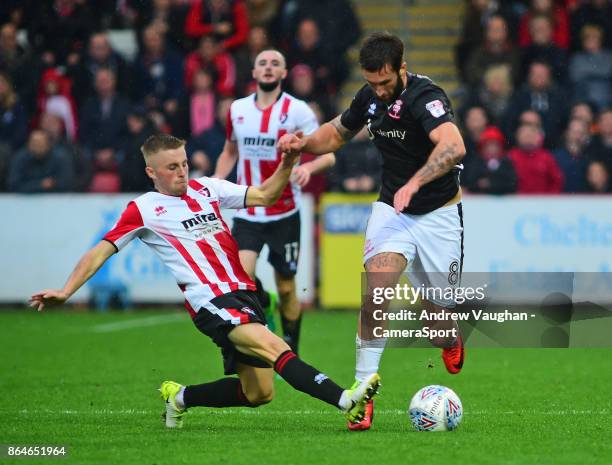 Lincoln City's Ollie Palmer vies for possession with Cheltenham Town's Joe Morrell during the Sky Bet League Two match between Cheltenham Town and...