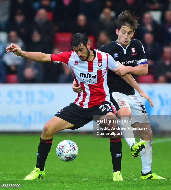 Lincoln City's Alex Woodyard vies for possession with Cheltenham Town's Brian Graham during the Sky Bet League Two match between Cheltenham Town and...