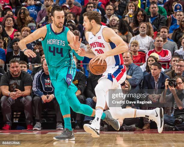 Jon Leuer of the Detroit Pistons drives to the basket on Frank Kaminsky of the Charlotte Hornets during the Inaugural NBA game at the new Little...