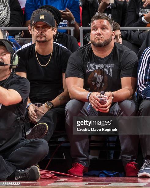 Kid Rock and Dominic Raiola, Detroit Lions assistant strength coach watch the play from the sidelines during the Inaugural NBA game between the...