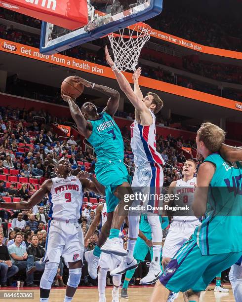 Dwayne Bacon of the Charlotte Hornets drives to the basket on Jon Leuer of the Detroit Pistons during the Inaugural NBA game at the new Little...