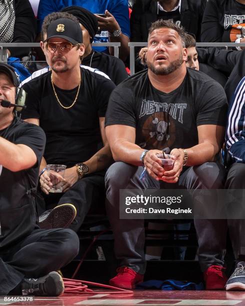 Kid Rock and Dominic Raiola, Detroit Lions assistant strength coach watch the play from the sidelines during the Inaugural NBA game between the...