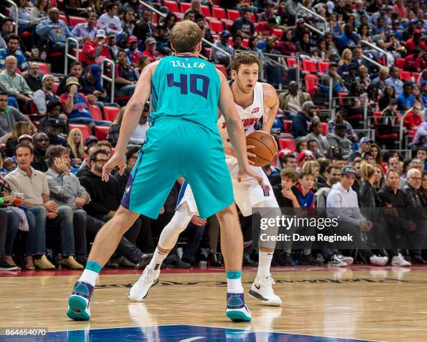 Jon Leuer of the Detroit Pistons looks to pass the ball in front of Cody Zeller of the Charlotte Hornets during the Inaugural NBA game at the new...