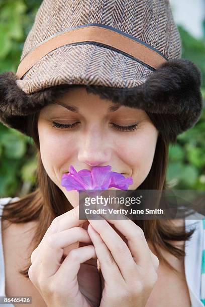 woman smelling morning glory flower - ipomoea fotografías e imágenes de stock
