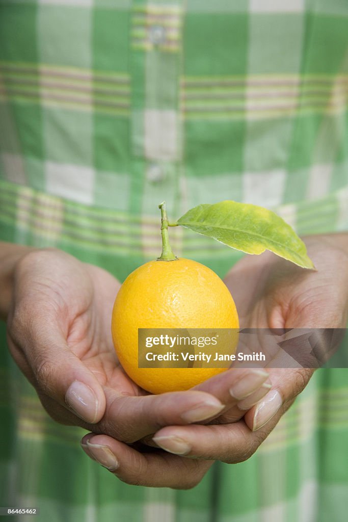 Woman holding orange