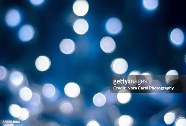 christmas winter bokeh light blue tones background - blue baubles stock pictures, royalty-free photos & images