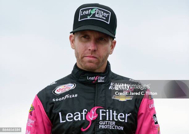 Blake Koch, driver of the Breat Cancer Honor & Remember Chevrolet, stands on the grid during qualifying for the NASCAR XFINITY Series Kansas Lottery...