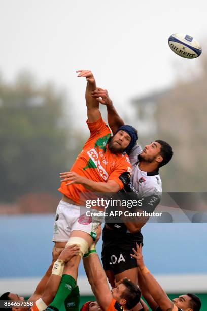 Enetton Treviso's New Zealander flanker Dean Budd and Toulon's French lock Swan Rebbadj reach for the ball in a line out during the European Rugby...