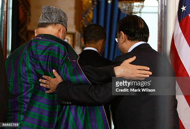 Afghan President Hamid Karzai and Pakistani President Asif Ali Zardari walk away after US President Barack Obama spoke at the White House May 6, 2009...