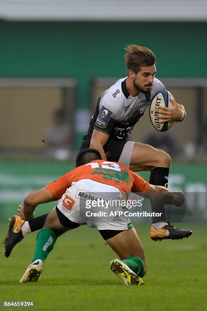 Toulon's French fullback Hugo Bonneval vies with by Benetton Treviso's Argentinian center Juan Ignacio Brex during the European Rugby Champions Cup...