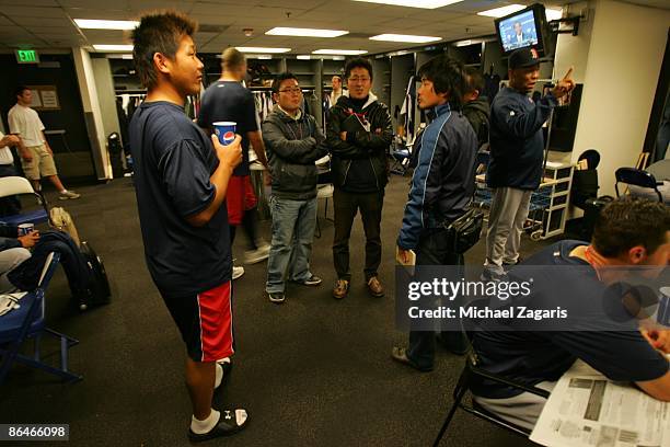 Daisuke Matsuzaka of the Boston Red Sox in the clubhouse with Japanese media prior to the game against the Oakland Athletics at the Oakland Coliseum...