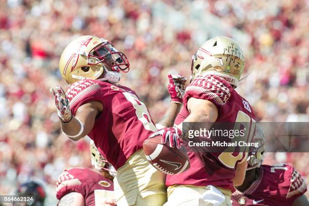 Tight end Ryan Izzo of the Florida State Seminoles celebrates with wide receiver Nyqwan Murray of the Florida State Seminoles after scoring a...