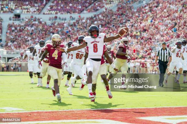 Quarterback Lamar Jackson of the Louisville Cardinals runs the ball into the endzone for a touchdown during their game against the Florida State...