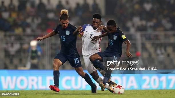 Ayo Akinola of the United States is challenged by Joel Latibeaudiere of England and Steven Sessegnon of England during the FIFA U-17 World Cup India...