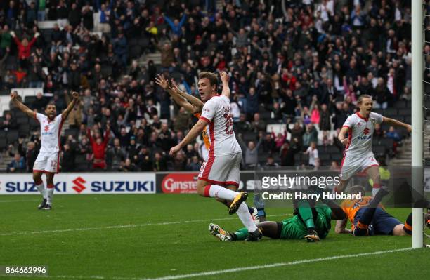 Ryan Seager of Milton Keynes Dons celebrates Ed Upson's goal during the Sky Bet League One match between Milton Keynes Dons and Oldham Athletic at...