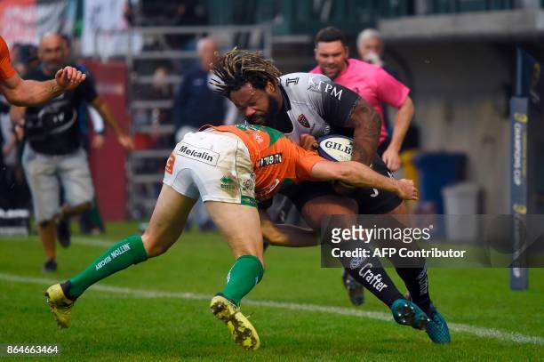 Toulon's French centre Mathieu Bastareaud is tackled by Benetton Treviso's Irish fullback Ian McKinley during the European Rugby Champions Cup rugby...