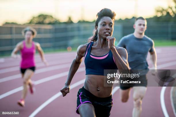 running a race - female sprinting stock pictures, royalty-free photos & images