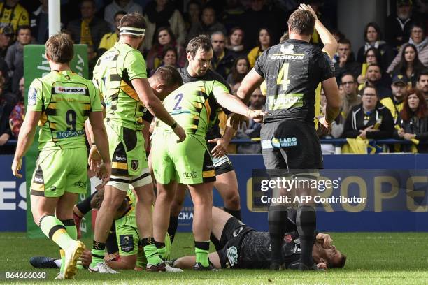 Clermont's French fly-half Camille Lopez lies in pain on the pitch after suffering a broken shinbone on his left leg during the European Rugby...