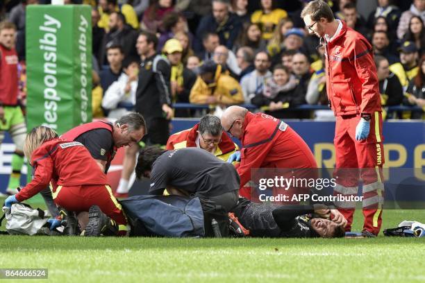 Medics tend to Clermont's French fly-half Camille Lopez after suffering a broken shinbone to his left leg during the European Rugby Champions Cup...