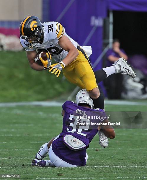Hockenson of the Iowa Hawkeyes is tackled by Nate Hall of the Northwestern Wildcats at Ryan Field on October 21, 2017 in Evanston, Illinois.