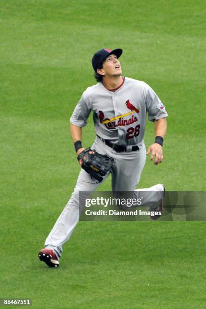 Outfielder Colby Rasmus of the St. Louis Cardinals jogs over to catch a fly ball off the bat of Nick Johnson of the Washington Nationals during the...