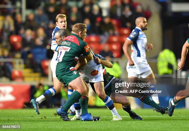 Castres' French centre Thomas Combezou is tackled by Leicester Tigers' English hooker Tom Youngs during the European Champions Cup Pool 4 rugby union...