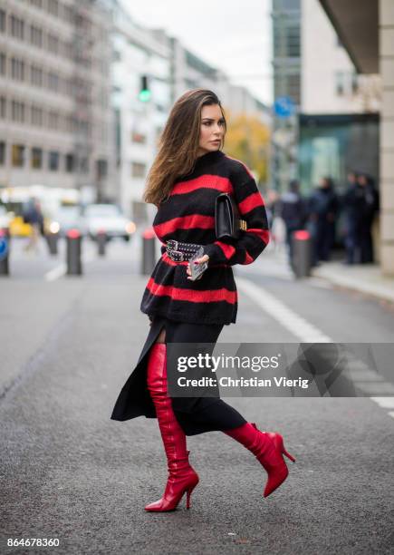 Miryam Labiad wearing red black striped Faith Connexion knit, Chloe skirt, black Rodarte belt, Dior hand bag, red Fendi overknee boots on October 21,...