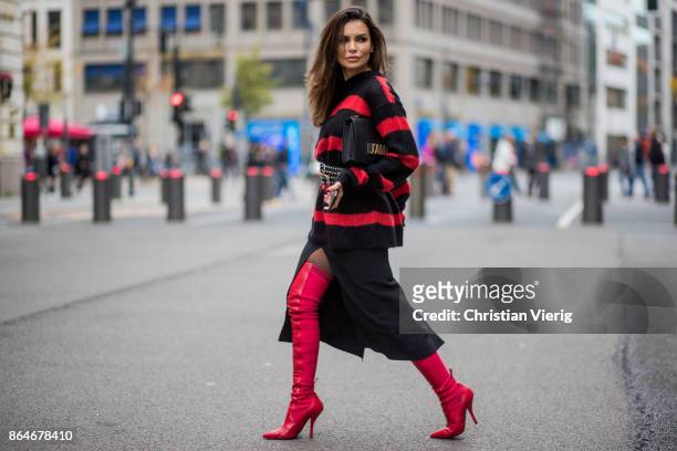 Miryam Labiad wearing red black striped Faith Connexion knit, Chloe skirt, black Rodarte belt, Dior hand bag, red Fendi overknee boots on October 21,...