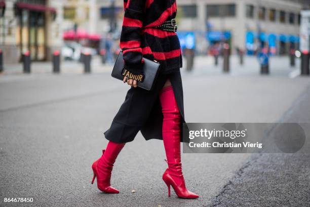 Miryam Labiad wearing red black striped Faith Connexion knit, Chloe skirt, black Rodarte belt, Dior hand bag, red Fendi overknee boots on October 21,...