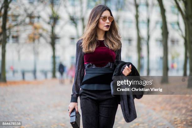 Miryam Labiad wearing Roland Mouret top and pants, black Celine fur jacket, Louis Vuitton clutch, Bulgari sunglasses on October 21, 2017 in Berlin,...