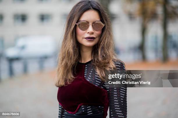 Miryam Labiad wearing Roland Mouret top and pants, black Celine fur jacket, Louis Vuitton clutch, Bulgari sunglasses on October 21, 2017 in Berlin,...