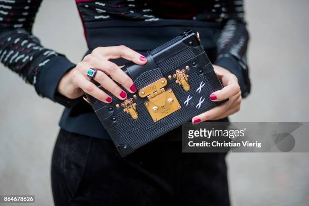 Miryam Labiad wearing Roland Mouret top and pants, black Celine fur jacket, Louis Vuitton clutch, Bulgari sunglasses on October 21, 2017 in Berlin,...