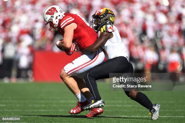 Troy Fumagalli of the Wisconsin Badgers is brought down by Darnell Savage Jr. #4 of the Maryland Terrapins during the second quarter at Camp Randall...